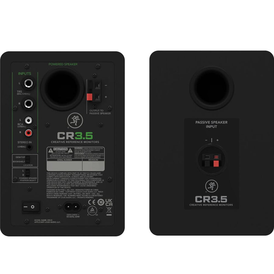 Two black studio monitors with labeled inputs on a white background